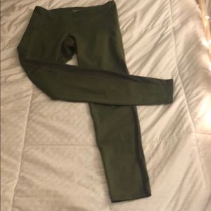 green leggings with side paneling and pockets